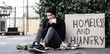 © Pixel-Shot - Homeless man with cardboard eating bread on street
