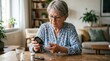 © Felippe Lopes - Elderly woman checking blood sugar levels at home with a glucose meter, managing diabetes