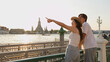 © blueringmedia - Young Asian Couple Pointing at Wat Arun Temple During Sunset