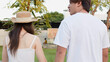 © blueringmedia - Rear View of Young Asian Couple Walking in Sunny Park