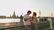 © blueringmedia - Young Couple Using Smartphone by Bangkok Riverside with Wat Arun Backdrop
