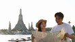 © blueringmedia - Young Asian Couple Holding Map Near Wat Arun Temple in Bangkok