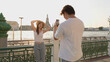 © blueringmedia - Young Asian Couple Taking Photos by Chao Phraya River at Sunset