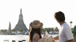 © blueringmedia - Young Asian Couple Holding Map Looking at Wat Arun Temple