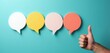 © miss irine - Four colorful empty speech bubbles arranged in a row with a hand giving a thumbs up gesture. This visually represents positive feedback, agreement, and good communication.