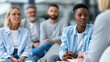 © Nataliya - Anonymous mixed-generation workforce sharing ideas during an inter-departmental workshop, knowledge exchange and team building concept, faceless, defocused modern office, with