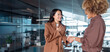 © Stock 4 You - Business woman entrepreneur hiring employee after successful interview. Two businesswomen shaking hands in office, smiling during professional meeting, teamwork and partnership. Banner, copy space