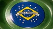 © meherab - Close-up of the Brazilian flag emblem on a green surface, featuring a yellow diamond and white stars on a blue background with the motto 'Ordem e Progresso'.