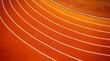© pat pat - High angle view of orange running track lanes with white lines