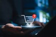 © Sultana - Online shopping cart and e-commerce purchase concept. Person using smartphone and laptop with cart icon, item notification, mobile checkout, digital retail, order process, and online buying experience