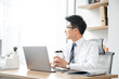 © DoThanhKhanh - Businessman with takeaway coffee taking a work break in a modern office