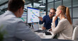© Andrey Popov - Project Manager And Diverse Team Discuss Tasks