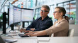 © Andrey Popov - Young Man And Woman Reviewing Payroll Automation System