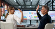 © Andrey Popov - Two Financial Analysts Celebrate Reaching Key Performance Goals