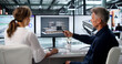 © Andrey Popov - Two Engineers Discuss 3D Building Plans Using BIM Software