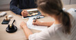 © Andrey Popov - Insurance Agent And Client Review Claim Forms During Property Damage