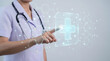 © SmartTech - Female Health Professional Pointing at Glowing Medical Icon and Digital Interface Concept