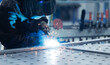 © Parilov - Welder performing arc welding on steel worktable in factory