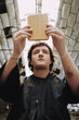 © Luciano Spinelli/Stocksy - Young Man Holds mirror during haircut session