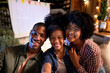 © Jovo Jovanovic/Stocksy - Smiling family takes a selfie at an outdoor movie night.