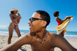 © BONNINSTUDIO/Stocksy - Friends enjoying sunny summer beach day