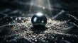 © Formoney - Metal sphere resting among glittering granules on dark fabric