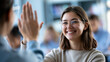 © Laura - Faceless teacher giving a high-five to a smiling girl student in a classroom, celebration of academic achievement, defocused classroom interior in background, education mentorship