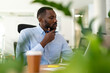 © Dexon Dee - Black entrepreneur concentrating on work in modern office