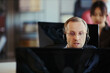 © DragonImages - Middle aged Caucasian man wearing headset, assisting customers and monitoring computer in call center office. Ideal for customer support, help desk, outsourcing, service team marketing
