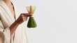 © pier - elegant woman hand holding matcha whisk in minimalist editorial style