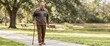 © Xenia - Senior man walking in a park with a cane. Elderly person enjoying a stroll outdoors