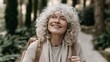 © Oleksandr - Joyful Mature Woman with Curly Hair and Headphones Hiking in a Serene Forest, Embracing Nature and Wellbeing, Headshot Portrait of a Happy Healthy Senior Female Traveler Outdoor