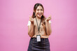 © Reezky - Lovely young Asian woman in a brown shirt making a finger heart gestures.