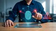 © Hamzah - Cybersecurity fraud risk analysis concept with man interacting with glowing fingerprint network and digital warning hologram on transparent tablet