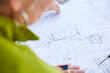 © Westend61 - Architect pointing at building floor plan during business planning
