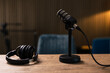 © Westend61 - Microphone by headset on desk in recording studio