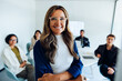 © Julia - Business leader woman confidently posing with her team