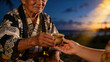 © Future Vision - Offering senior man in kimono handing ceramic cup at coast dusk, with beads, bracelet, copy space