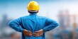 © Yevheniiya - Construction worker in yellow hard hat experiencing back pain outdoors
