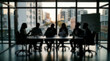 © REAL  - Soft focus blurred photo of Business team having a meeting in a modern office with a city skyline view