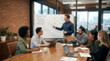 © REAL  - Soft focus blurred photo of Business team having a creative meeting with a man pointing at a whiteboard in a modern office with brick wall
