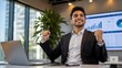 © Lerivan - Successful businessman celebrating a win with fists pumped in modern office setting