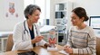 © AlfaSmart - Woman doctor showing thyroid model to young woman patient in clinical office. Medical consultation regarding endocrine system. Endocrinology health checkup and diagnostic examination.