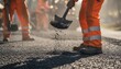 © ANDREY PROFOTO - Road construction workers spreading asphalt for pavement repair