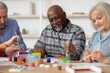 © Prostock-studio - Happy Black Male Senior Engaged In Painting Activity Alongside Group Of Adults, Enjoying Art Class In Creative Studio, Fostering Creativity And Social Interaction. Art And Community Concept.