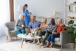 © Prostock-studio - Joyful Senior Diverse Group Of Six, Including Men And Women, Engaged In Conversation While Enjoying Snacks And Beverages At Home. Comfortable Living Room Setting, Promoting Community And Wellbeing.