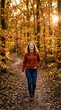 © Istar - Happy young woman walking through golden autumn woods at sunset