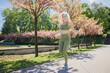 © Cavan Images - Blonde middleaged sporty woman jumping rope in spring sunny city park