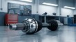 © Pixels Stock - Automotive CV joint or driveshaft component on workshop floor with tools and equipment in background demonstrating industrial mechanical engineering and auto repair.