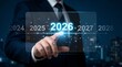 © Mayla - 2026 business planning and innovation concept entrepreneur selecting future year on virtual interface representing strategy, transformation. new